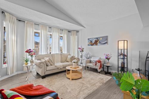 a living room with two couches and a table at Spacious & Comfy Upper Floor 3BR Suite in Detached House in Calgary