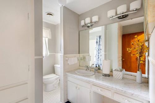 a white bathroom with a sink and a toilet at Abbies Place in Pine Bluff in Pine Bluff