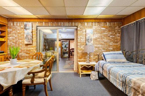 a bedroom with a bed and a table and a dining room at Abbies Place in Pine Bluff in Pine Bluff