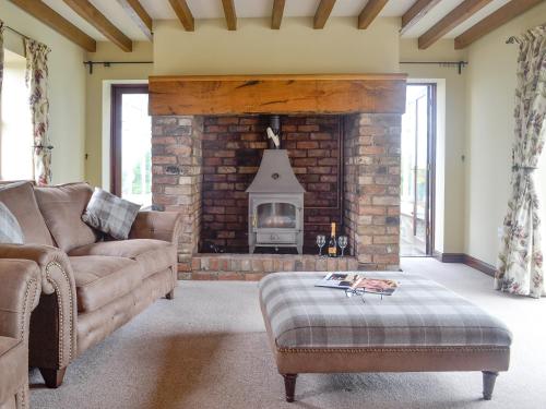 a living room with a couch and a fireplace at Green Lane Cottage in Newtown