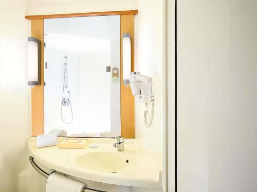 a bathroom with a sink and a mirror at ibis Jaipur City Centre - An Accor Brand in Jaipur