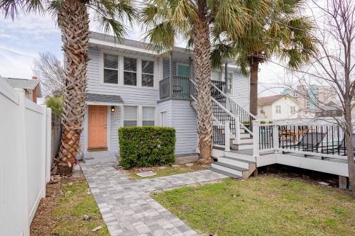 a white house with palm trees in front of it at Beach Retreat Complex w Pool - Sleeps 25 in Jacksonville Beach