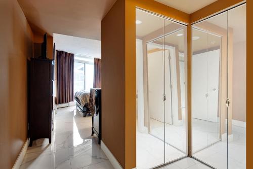 a bathroom with a glass shower in a room at Modern 2BR Luxury Apartment - Amazing Location, Steps To Everything! in Vancouver