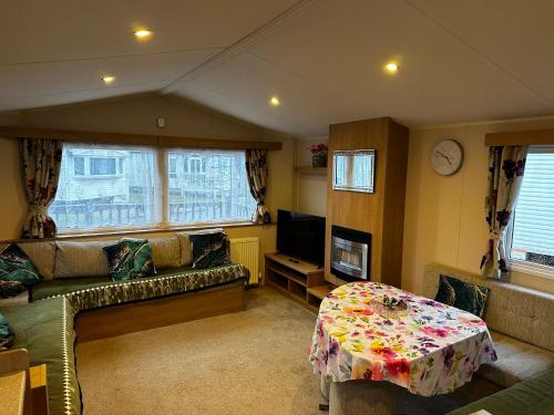 a living room with a couch and a table at The Springs 22-Sara in Lincolnshire