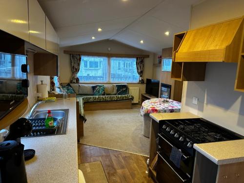 a kitchen and living room with a stove top oven at The Springs 22-Sara in Lincolnshire