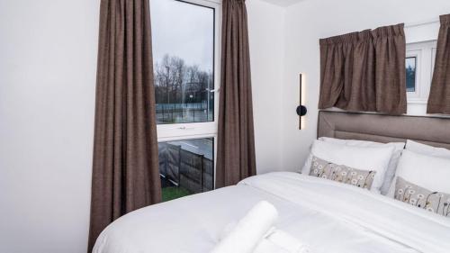 a bedroom with a white bed and a window at The Way House in Manchester