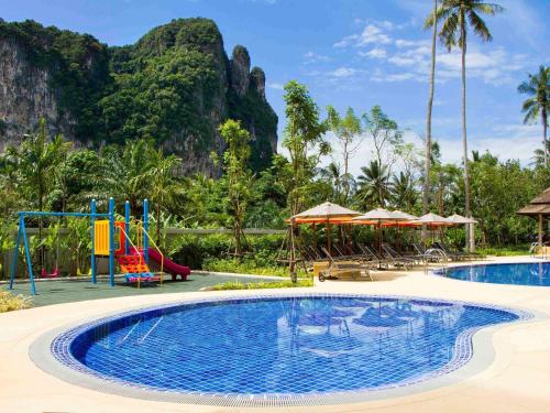 a pool at a resort with a playground at ibis Styles Krabi Ao Nang in Ao Nang Beach