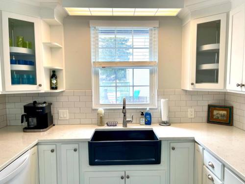 a kitchen with a sink and a window at Coastal Cape Cod w/ King Bed, Game Room, & Bikes! in Vermilion
