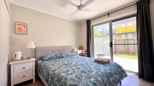 a bedroom with a bed and a large window at Market Square Modern Haven - Near QEII and Griffith Uni in Brisbane