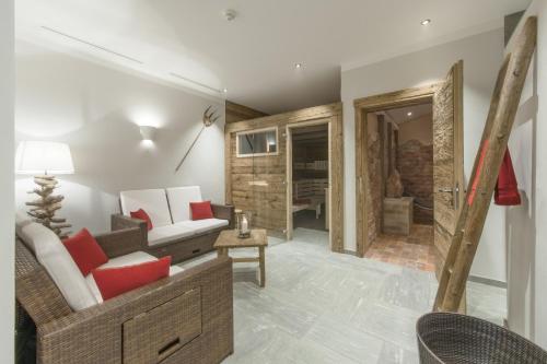 a living room with a couch and a table at Hotelino Petit Chalet in Celerina