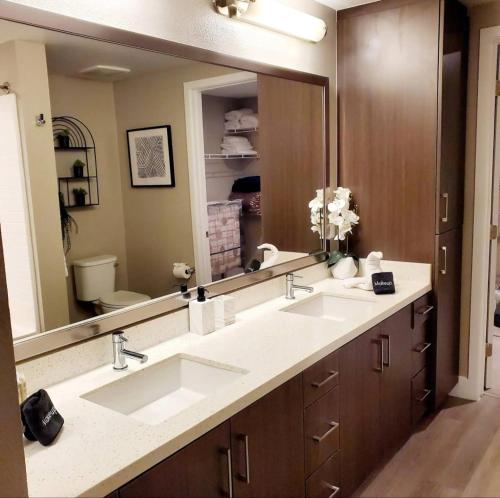 a bathroom with two sinks and a large mirror at Spacious 2 bed 2 bath, Pool, Hottub, Wifi, 24 hr Fitness, Parking in Los Angeles