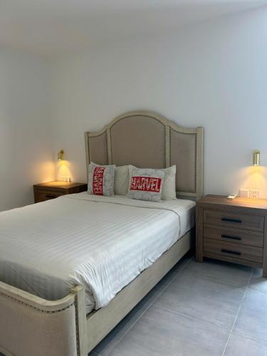 a bedroom with a large bed with two night stands at Windy Beach House 1 in Ấp Bình Tú