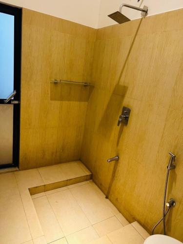 a shower stall in a bathroom with a toilet at Sharta Yala in Tissamaharama