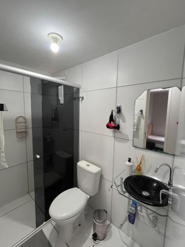 a bathroom with a toilet and a sink and a shower at Ap condomínio Bosque com piscina in Garanhuns
