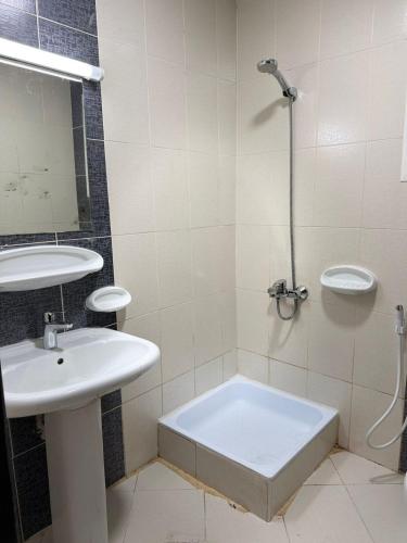a bathroom with a sink and a shower and a tub at Studio appartment well Furnished in Ajman