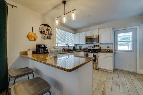 a kitchen with white cabinets and a counter top at Cozy bungalow with Luxe Yard, Firepit, Pergola Area in Tampa