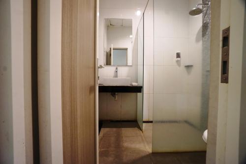 a bathroom with a sink and a mirror at Buring Residence By TOS Malang in Samaan