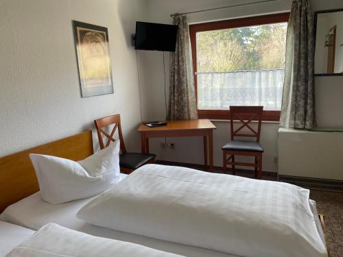 a hotel room with two beds and a window at Dresdner Höhe in Dresden