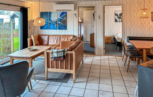 a living room with a couch and a table at Amazing Home In Ørsted With Sauna in Ørsted