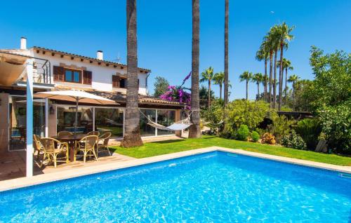 a villa with a swimming pool and a house at Can Tomeu De Llubi in Llubí