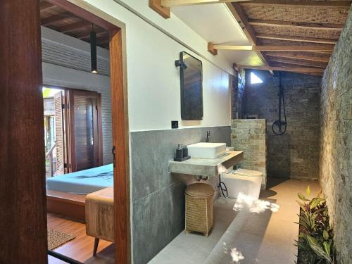 a bathroom with a sink and a toilet at Mantra Yoga Homestay in Tanjung