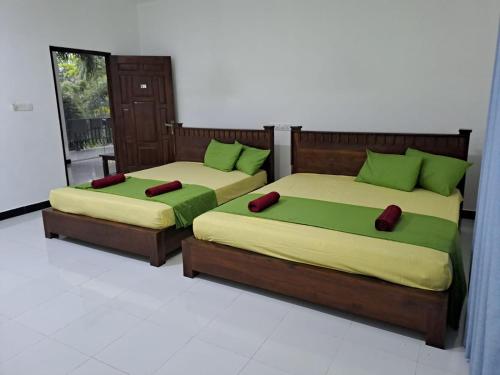 two beds sitting next to each other in a room at Bellamoon Resort in Trincomalee