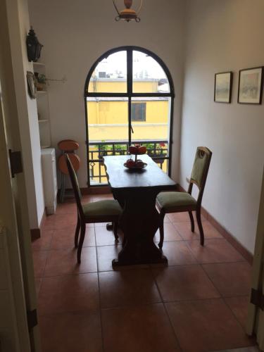 a table and chairs in a room with a window at Best place in Plaza Mayor Lima, Pizarro building in Lima