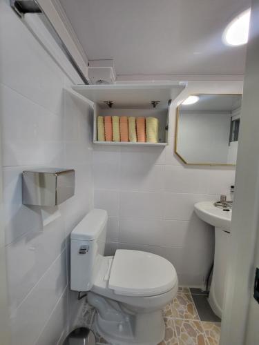 a small bathroom with a toilet and a sink at dalcom kunkuk in Seoul