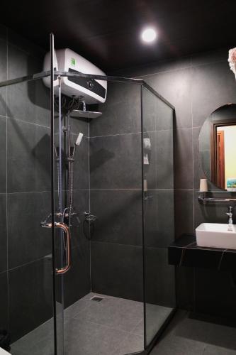 a bathroom with a shower with a blow dryer at AS Hotel Đà Lạt in Da Lat