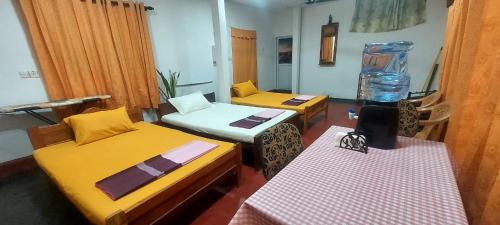 a small room with two beds and a blender at Bird Nest Homestay in Jaffna