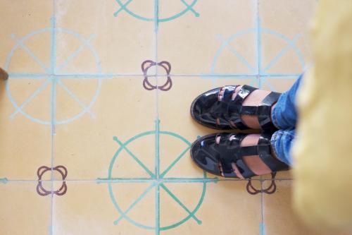 a person wearing black shoes on a tiled floor at La Grulla Dorada in Perales del Puerto