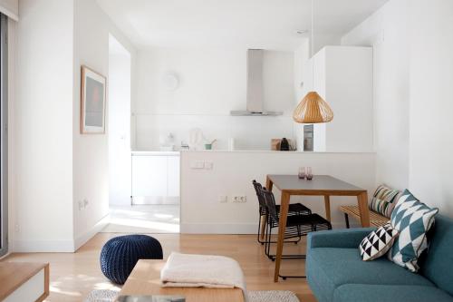 a living room with a blue couch and a table at 60 Balconies Art in Madrid