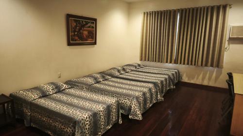a living room with a couch and a window at Pension Natividad in Manila