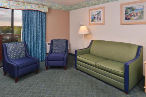 a living room with a couch and two chairs at Atlantis Family Waterpark Hotel, an Ascend Collection Hotel in Wisconsin Dells