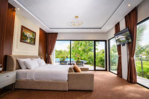 a bedroom with a bed and a large window at Nirvana Hotel Resort Tetebatu in Tetebatu