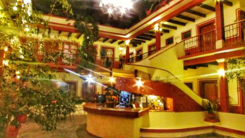 a building with a staircase in the middle of a room at Hotel Real del Valle in San Cristóbal de Las Casas