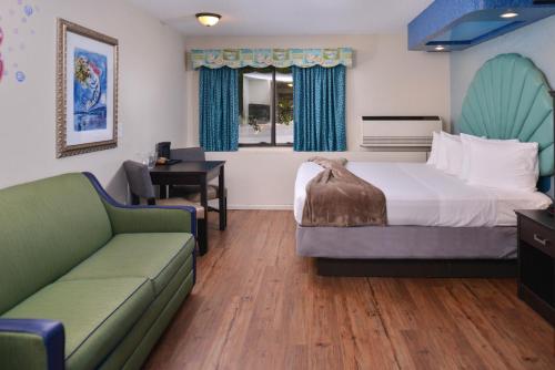 a hotel room with a bed and a couch at Atlantis Family Waterpark Hotel, an Ascend Collection Hotel in Wisconsin Dells