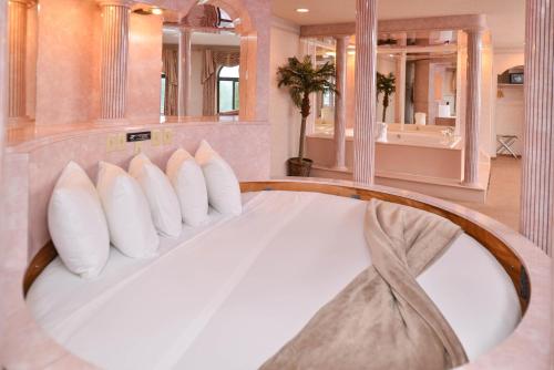 a bedroom with a large bed with white pillows at Atlantis Family Waterpark Hotel, an Ascend Collection Hotel in Wisconsin Dells