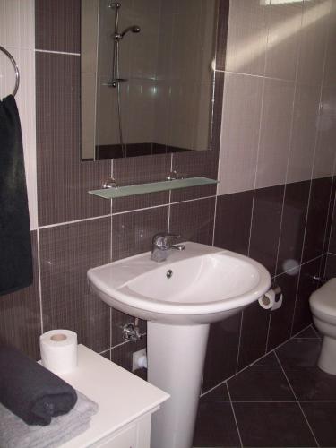a bathroom with a sink and a toilet and a mirror at Hotel Vanilla in Fethiye