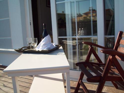 a white table with a bottle of wine and a glass at Hotel Vanilla in Fethiye