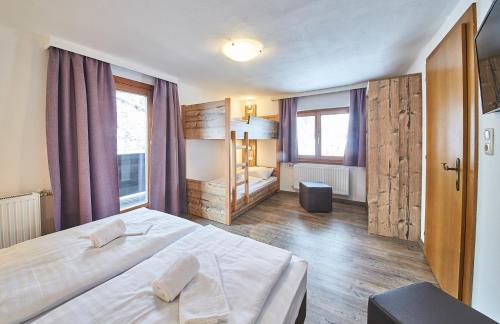 a bedroom with a large white bed in a room at Holiday Lodge Fabian in Saalbach Hinterglemm