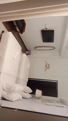a room with a pile of pillows and a tv at Sunset Beach Retreat & Beach Bistro in Batu Ferringhi