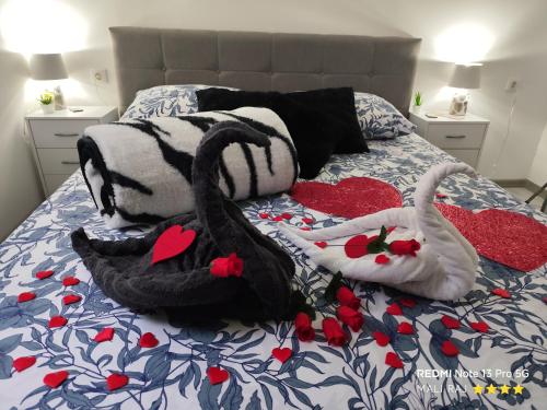 two stuffed animals are laying on a bed at Apartment Mali Raj -Stunning Gacka River View-Peaceful Nature Escape in Otočac