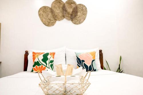 a basket filled with books sitting on a bed at PEPAYEN Homestay in General Luna