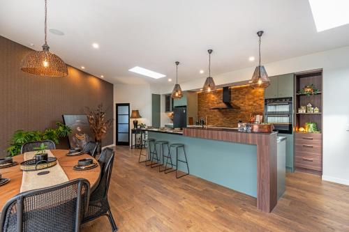 a dining room and kitchen with a table and chairs at Riverside Retreat Entire home in Palmerston North