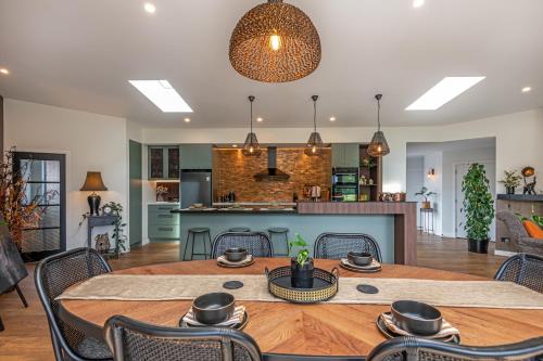 a dining room and kitchen with a table and chairs at Riverside Retreat Entire home in Palmerston North
