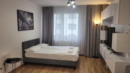 a small bedroom with a bed and a window at Przestronny Apartament typu Studio, GARAŻ W CENIE in Wrocław