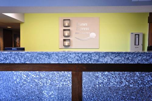 a blue counter top in a room with a wall at Dunes Express Inn and Suites in Hart