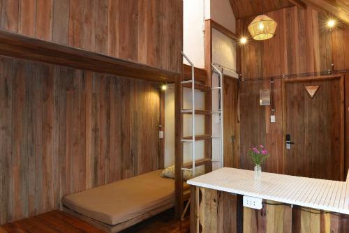 a room with a bunk bed and a counter at Yugen Village in Khu Chi Lăng