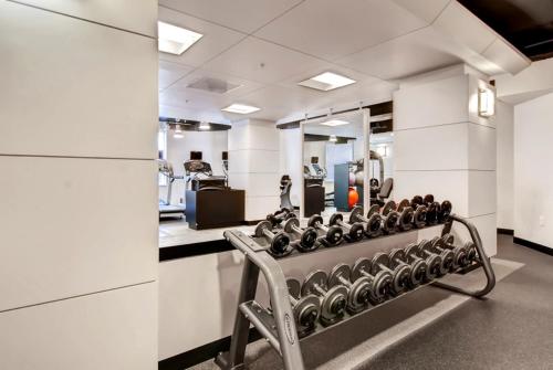 a gym with a bench with weights at Global Luxury Suites at The White House in Washington